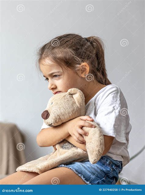 Portrait Of A Sad Little Girl With A Teddy Bear Stock Photo Image Of