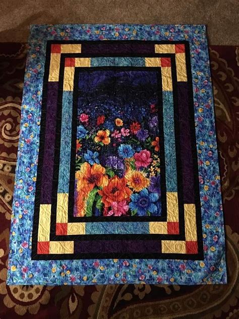 A Quilted Table Runner With Colorful Flowers On It