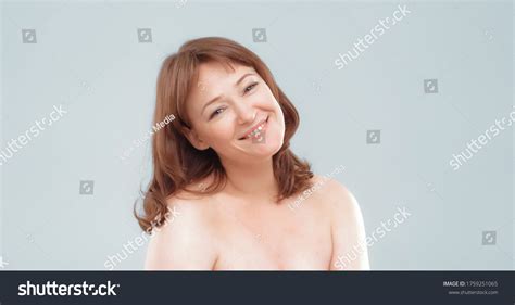 Red Haired Nude Woman Smiling Cheerfully Stock Photo