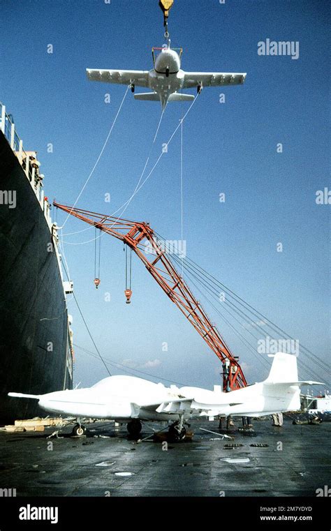 A Floating Crane Lowers The Second A 37 Dragonfly Aircraft From The