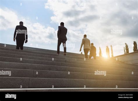 Business people climb the steps of the city stairs. impersonal rising