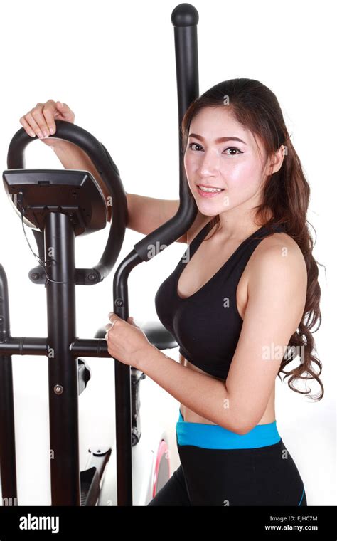 Young Woman Doing Exercises With Exercise Machine On White Background