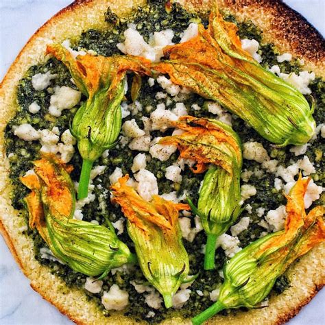 Am i in a really bizarre reboot episode of punk'd? Cauliflower Crust Squash Blossom Pizza with Kale Cashew Pesto and Vegan Mozzarella! I used the ...