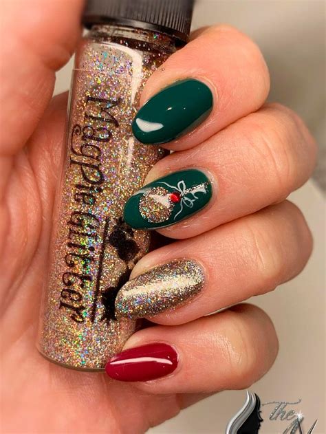 Cute Dark Green Christmas Nails With Gold Glitter And Accent Red Nail