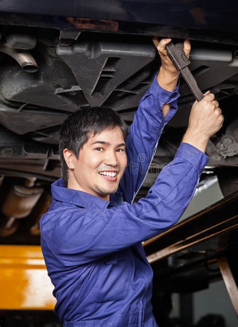 Happy Mechanic Working Underneath Lifted Car Stock Photos Free