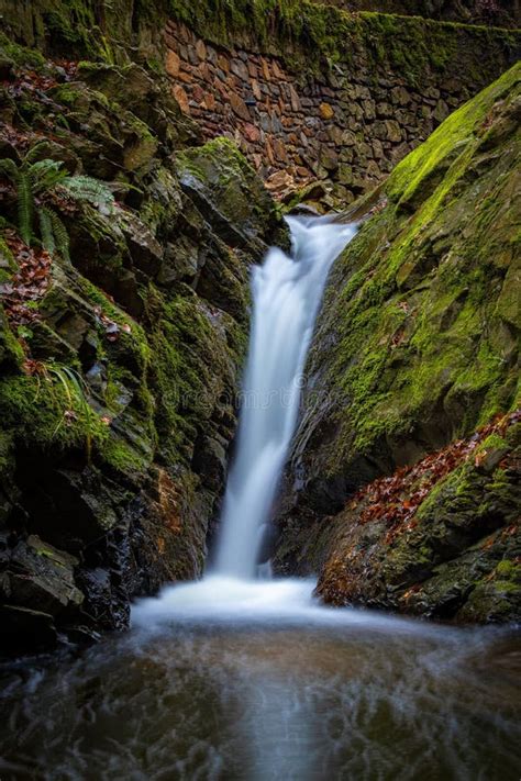 Long Exposure Shot Of A Beautiful Waterfall With Moss Rocks Stock Image