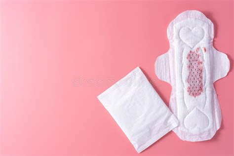 used sanitary pad sanitary napkin on pink background menstruation feminine hygiene top view
