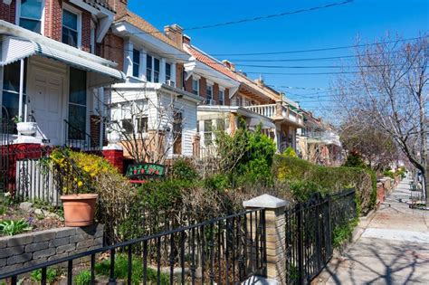 Row Of Neighborhood Homes With Green Plants During Spring In Astoria