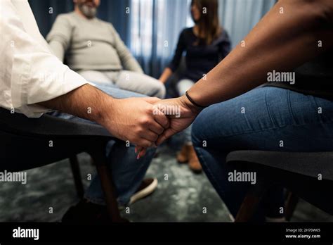 Mid Section Of People Holding Hands During Therapy Stock Photo Alamy