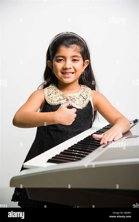Indian Kids Playing Piano Or Keyboard A Musical Instrument Isolated