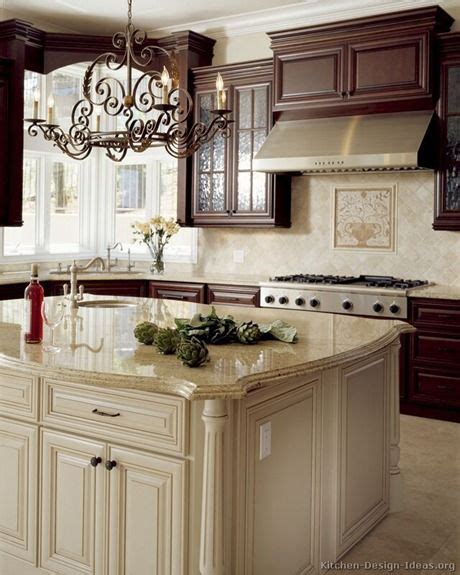 A combination of white and cherry custom cabinets give this kitchen a warm feel. cherry-kitchen-white-island | Antique white kitchen ...