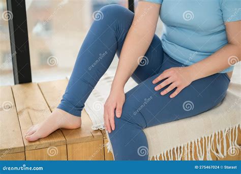 Knee Pain Woman Suffering From Ache And Doing Self Massage At Home