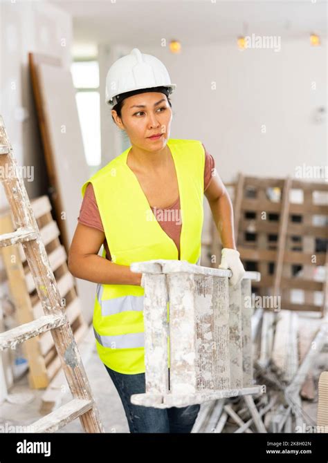 Woman Builder Carrying Stepladder Stock Photo Alamy