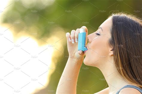 woman using an asthma inhaler ~ health photos ~ creative market