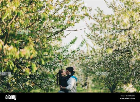 Caucasian Couple Kissing Near Trees Stock Photo Alamy