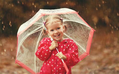 Happy Child Girl Laughing With An Umbrella In Rain Stock Image Image