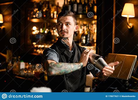 Tattooed Bartender Holding In Hands A Steel Shaker With A Deliciouds