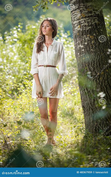 Attractive Young Woman In White Short Dress Posing Near A Tree In A Sunny Summer Day Beautiful