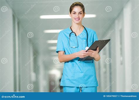 A Beautiful Young Woman Doctor Or Nurse Standing In Hospital Corridor
