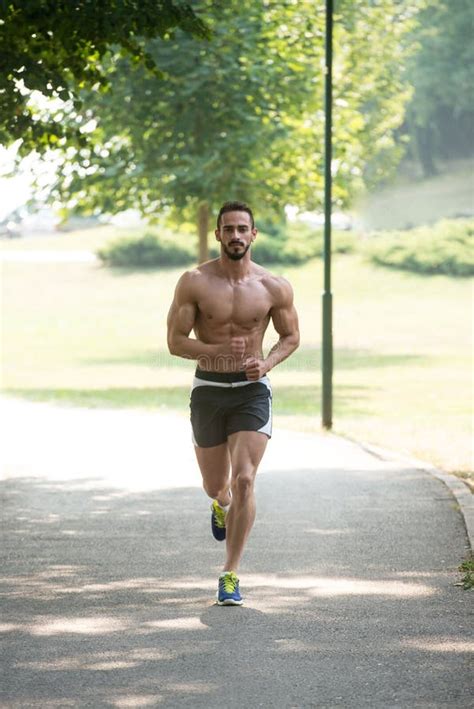Young Handsome Man Running In The Park Stock Photo Image Of Active