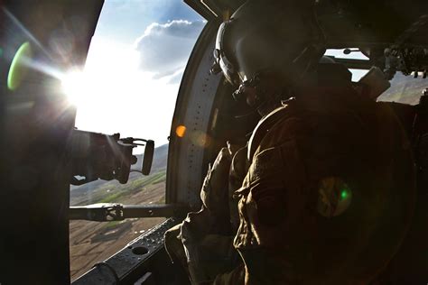 A Uh 60 Black Hawk Helicopter Door Gunner Provides Security While