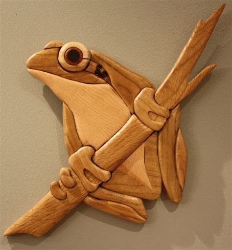 A Carved Wooden Bird With An Eye On Its Head And Wings Hanging From