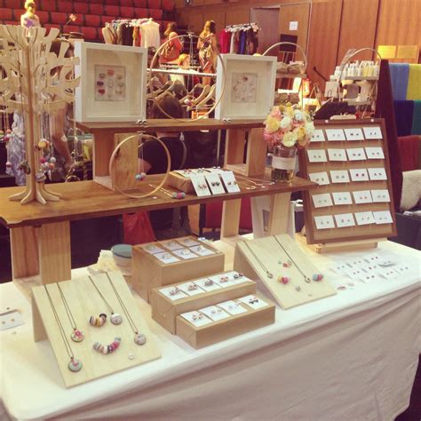 The Table Is Covered With Jewelry And Framed Pictures