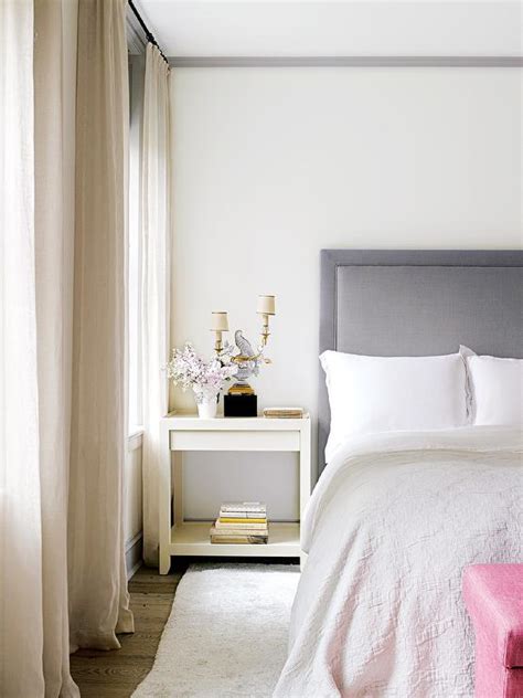Charming ivory bedroom boasts a mirrored nightstand placed on ebony wood floors against an ivory wall and topped with an ivory double gourd lamp. Grey and Pink Bedrooms - Transitional - Bedroom