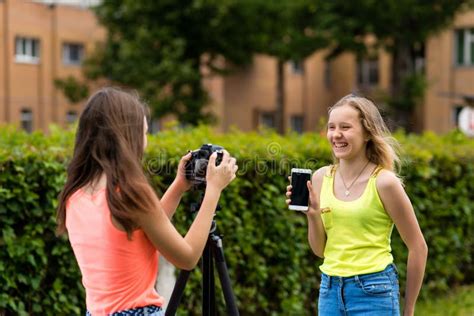 2 Girls Are Teenagers In The Summer In The Park In Nature Writes The Video To The Camera Here