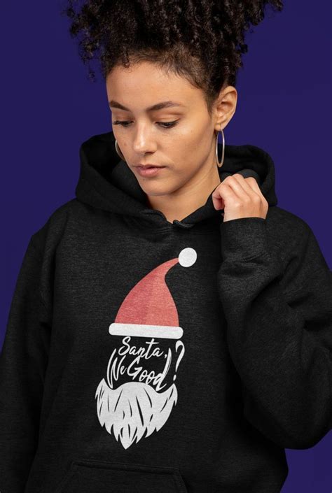 A Woman Wearing A Black Hoodie With A Santa Hat On It