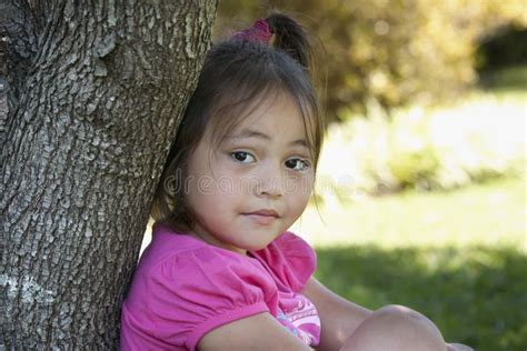 Asian Child Leaning On A Tree Stock Image Image Of Childhood Sitting