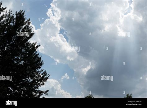 Sunrays Through Cumulus Clouds Stock Photo Alamy