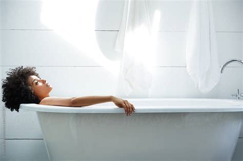 African American Woman Relaxing In Bathtub By Trinette Reed Stocksy