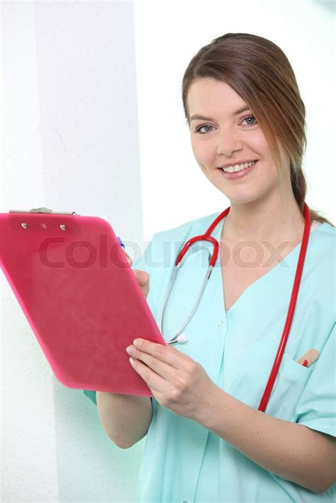 Nurse Looking At Clipboard Stock Image Colourbox