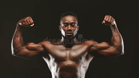 Black Athlete Flexing Muscles Demonstrating Strong Biceps Stock Image