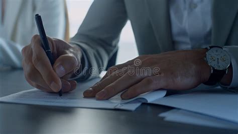 Man Hand Signing Papers In Office Closeup Insurance Client Checking
