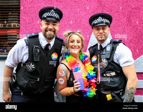 Two Metropolitan Policemen Pose With A Reveller At Pride In London Parade London Uk Stock