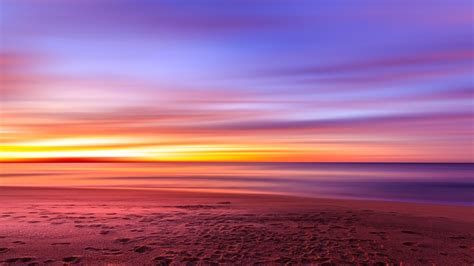 2048x1152 Purple Sky Beach Sunset Sand Footprints Wallpaper2048x1152