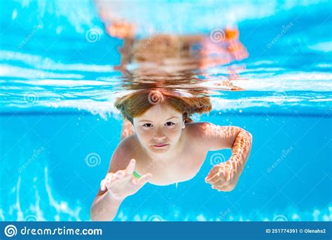 Child Swim And Dive Underwater In The Swimming Pool Stock Image
