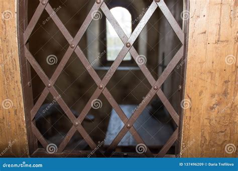 Ancient Prison Cell View Through A Window With An Iron Grid Stock