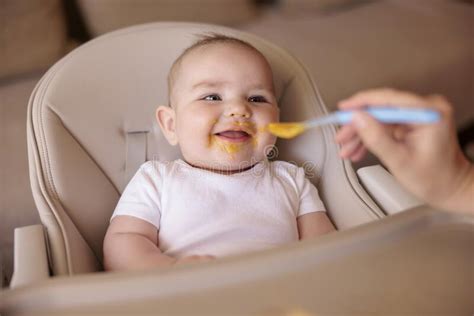 Baby Eating Porridge In High Chair Stock Image Image Of Mother Happy