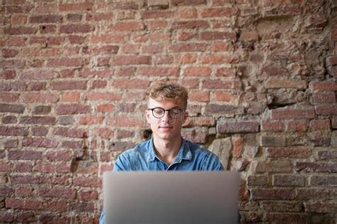 Young Man Successful Freelancer Using Laptop Computer For Work In