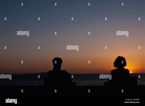 Silhouette Couple On Beach Sitting Hi Res Stock Photography And Images