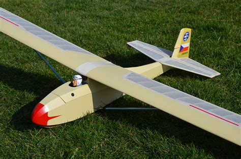 A Toy Airplane Sitting On Top Of A Lush Green Field