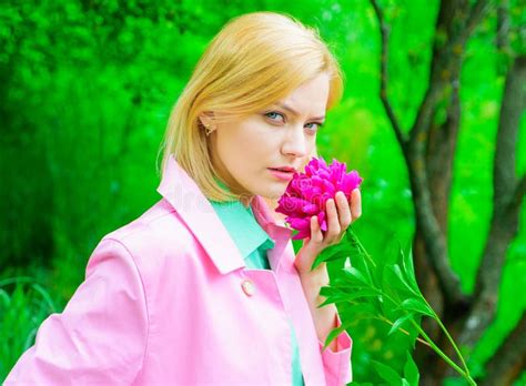 Sensual Woman In Pink Coat With Peony Flower In Park Romantic Girl