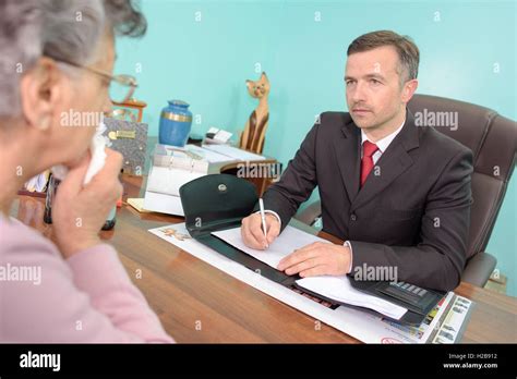 Funeral director talking to bereaved woman Stock Photo - Alamy