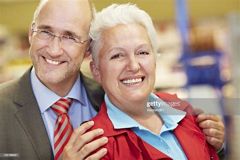 Germany Cologne Mature Couple In Supermarket Smiling Portrait Photo