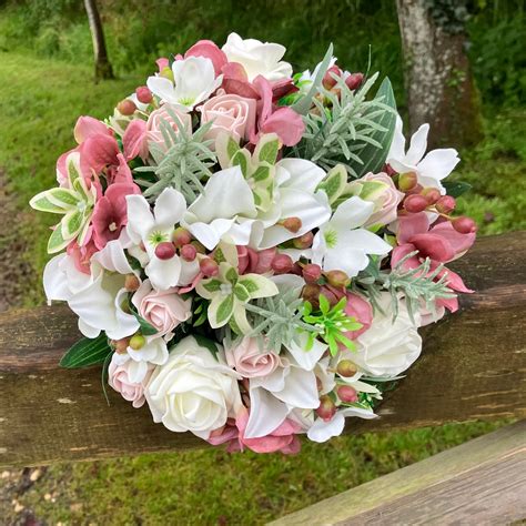 A Bridal Bouquet Featuring Artificial Silk Dusky Pink And Ivory Flowers