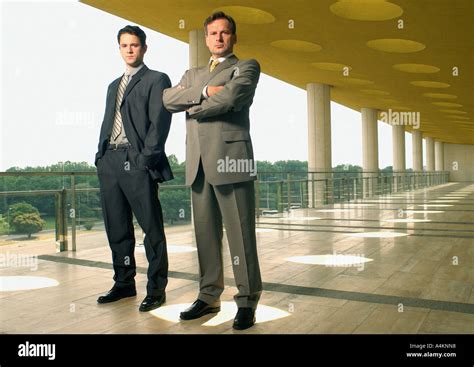 Two Businessmen Looking Into Camera Stock Photo Alamy