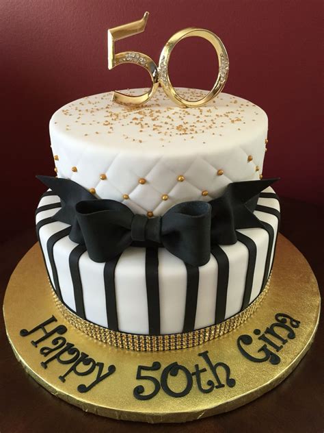 A 50th Birthday Cake Decorated With Black And White Stripes Gold